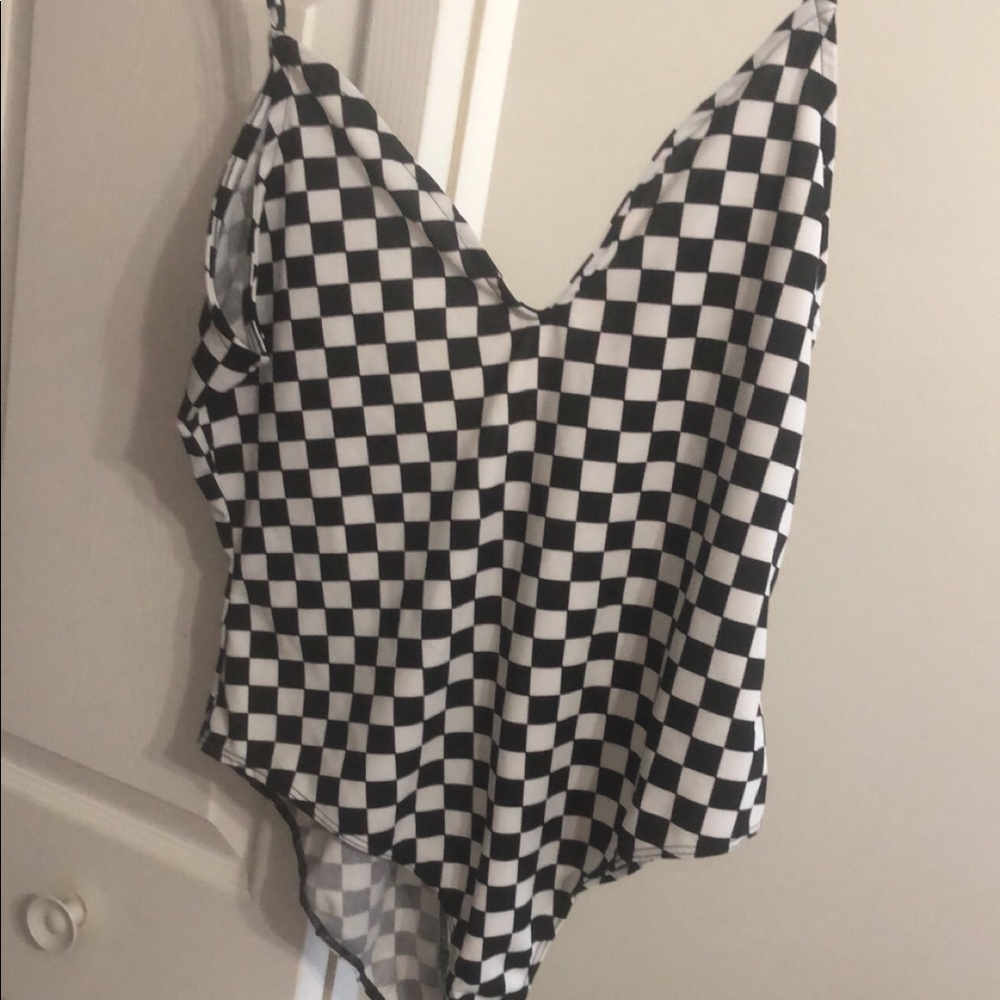 Cute checkered one piece. Cleavage revealing